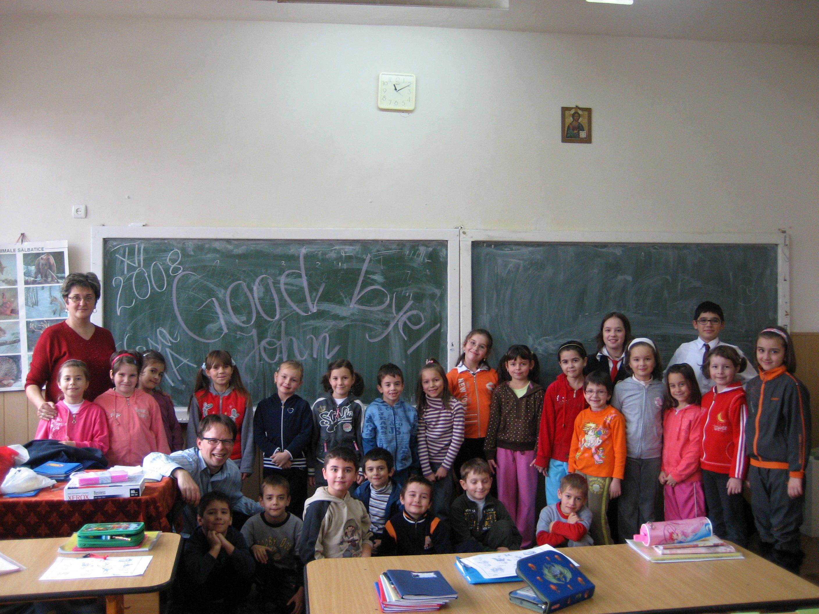 A volunteer teaching English in Romania takes a group photo with her students Projects Abroad volunteer and her students pose for a photo to mark the end of her teaching work experience in Romania